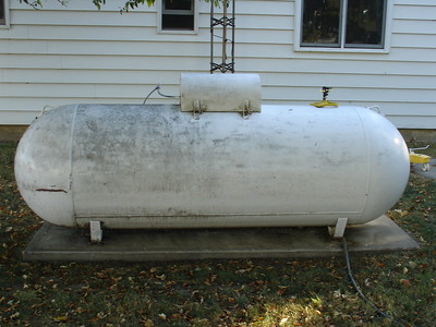 Can you put a 250 gallon propane tank next to a house?